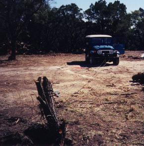 Get full size image - my Land Cruiser pulling a cedar stump at home using its Warn 8000lb winch.